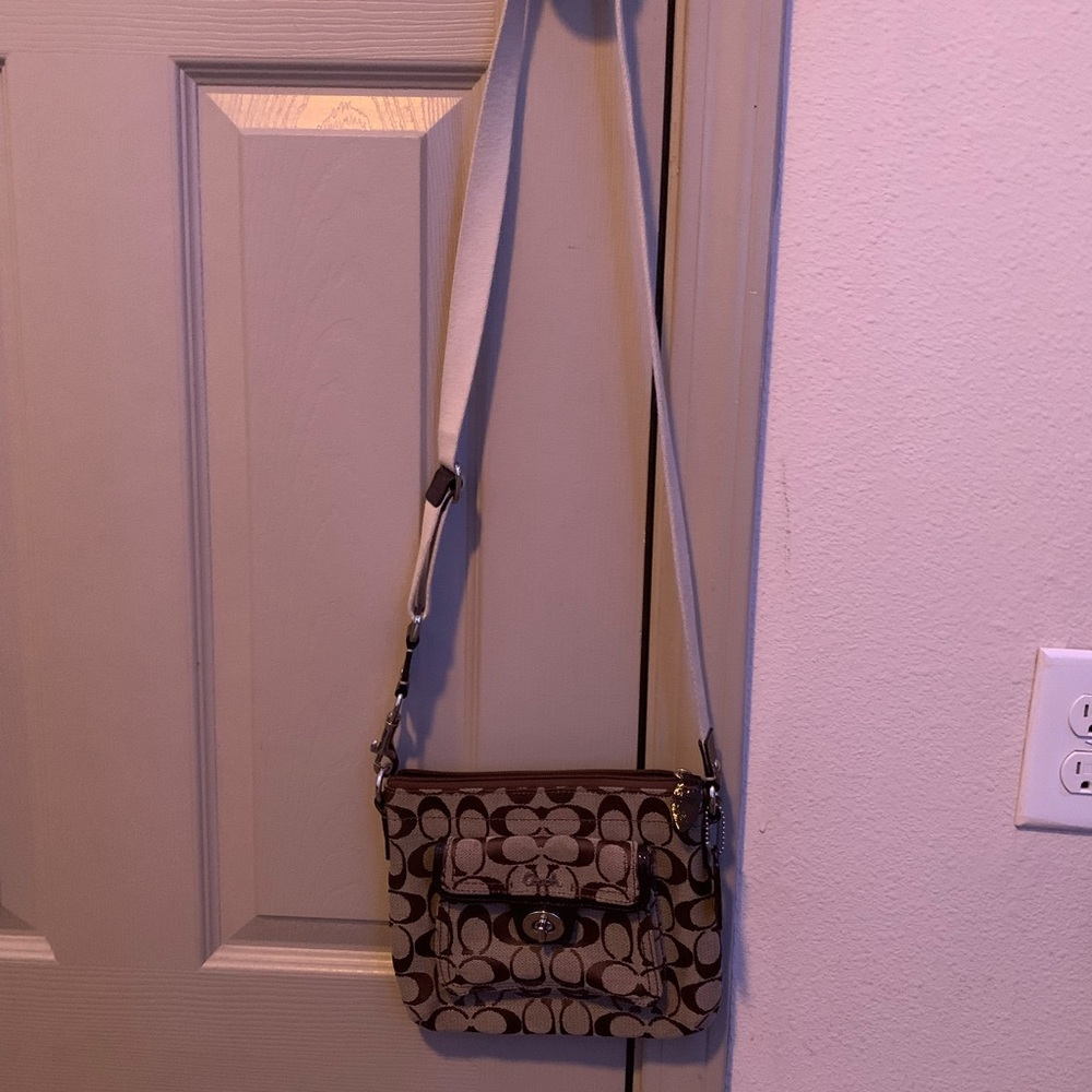 I am selling a coach signature brown turnlock swingpack crossbody bag.